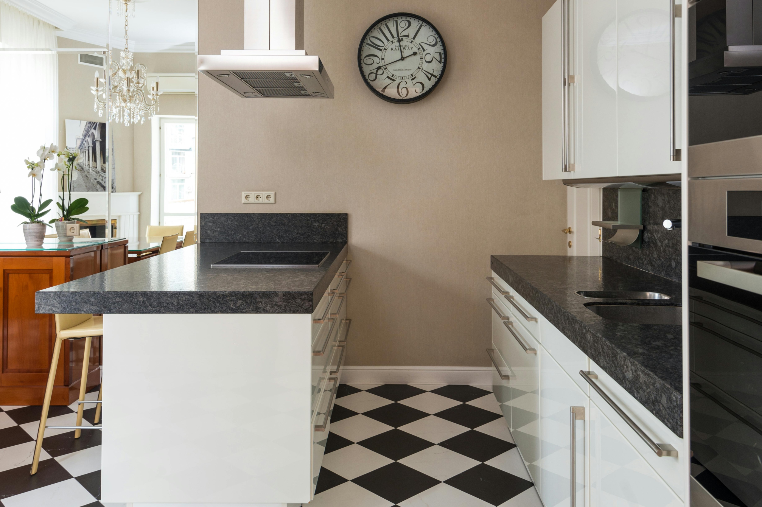 midcentury modern kitchen with black and white tile floor and granite countertops
