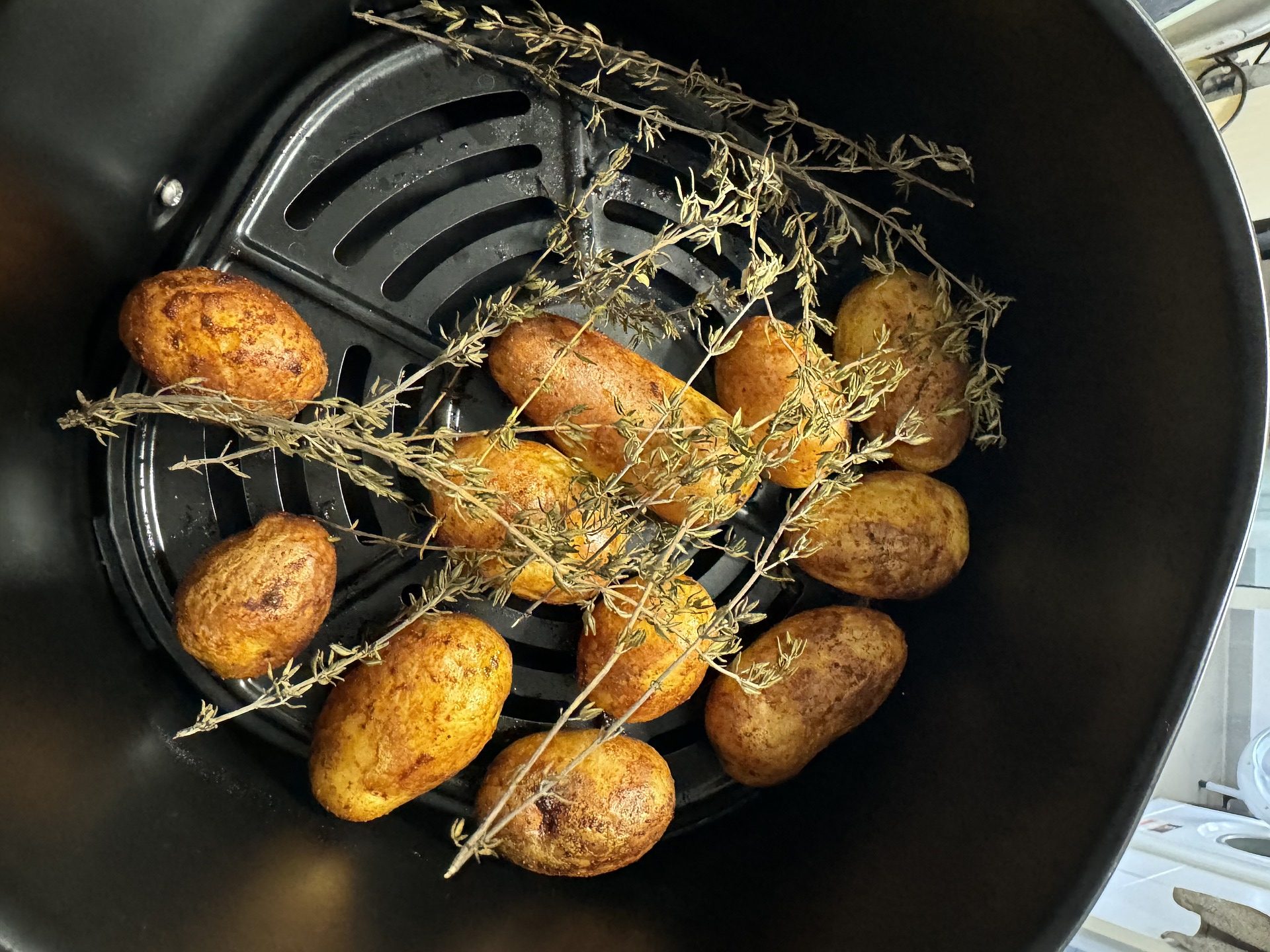 Potatoes and rosemary in an air fryer