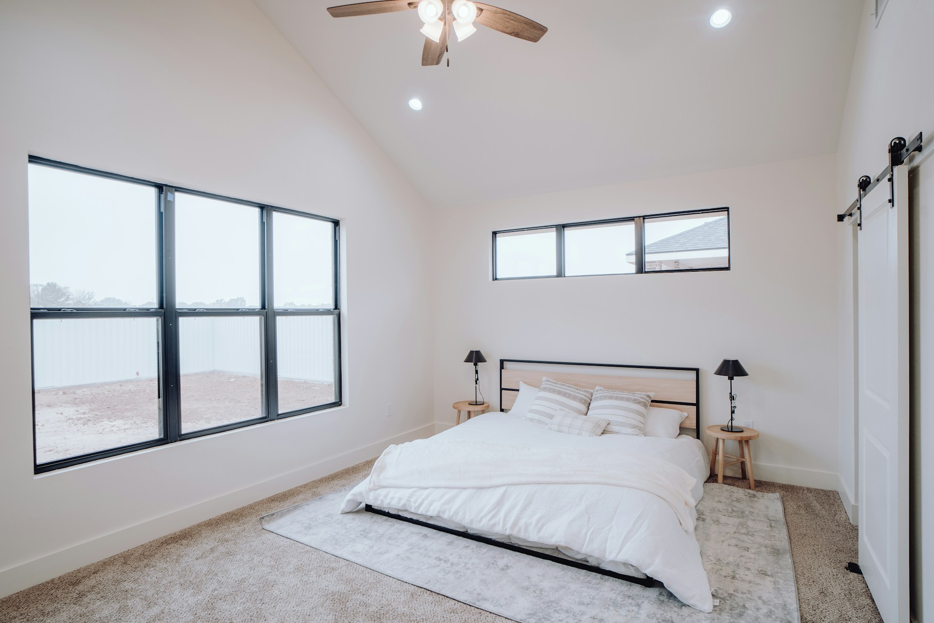 White bedroom with a vaulted ceiling
