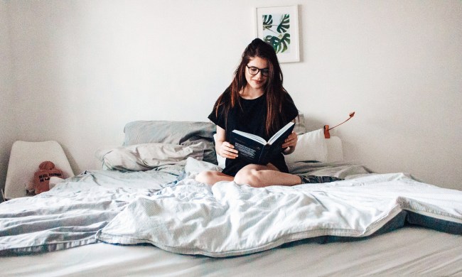 Woman reading a book in bed