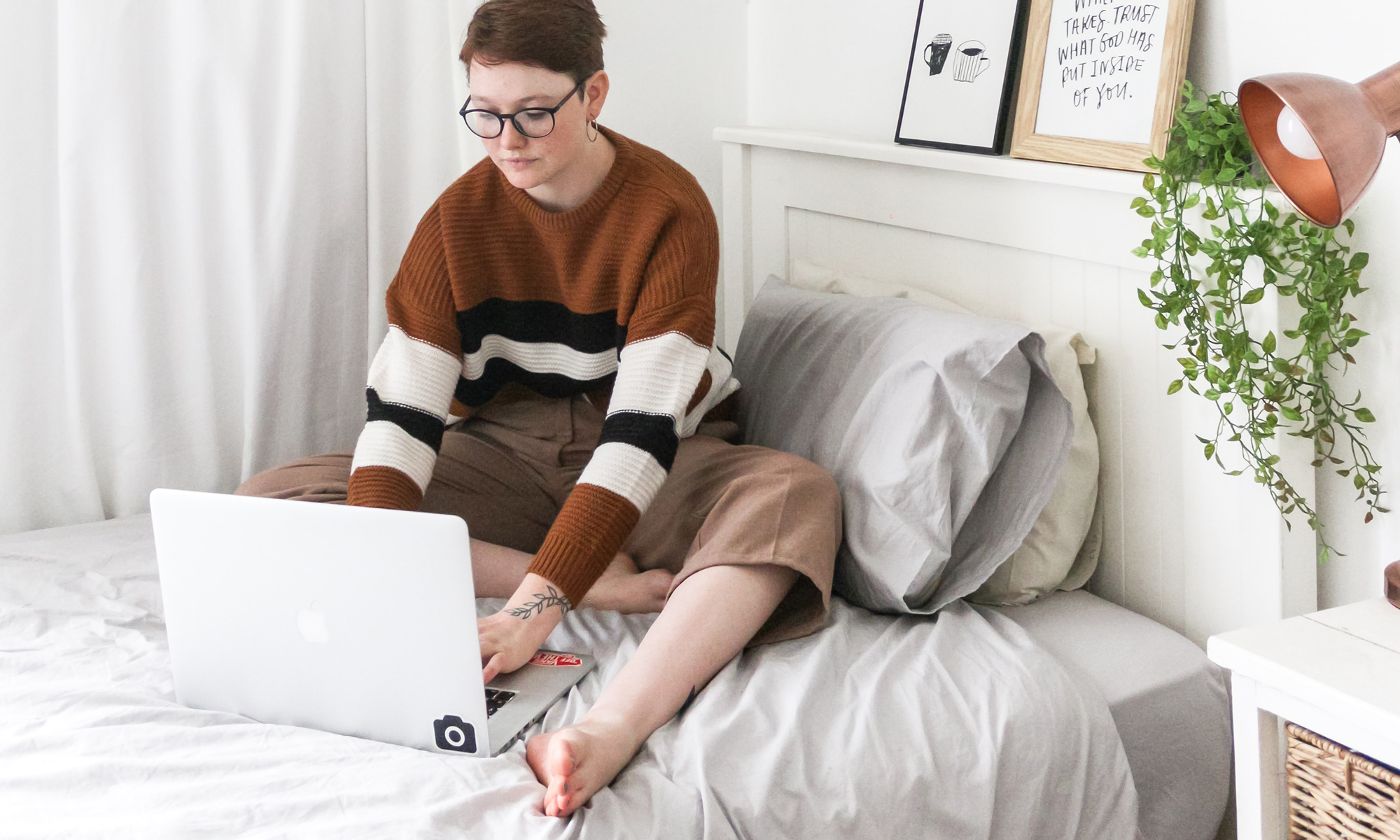 Woman using laptop on bed