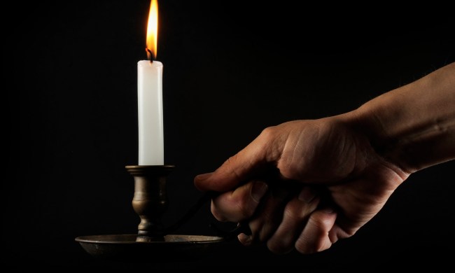 best candlesticks hand holding a lit candle in the dark