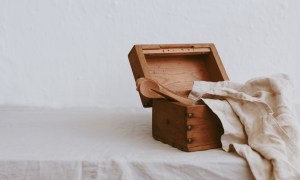 best candlesticks wooden box with kitchen utensils and a linen napkin