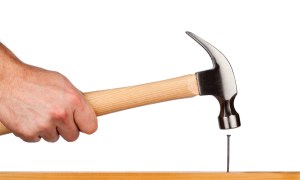 the best short extension cords for your home a hand holding hammer ready to nail