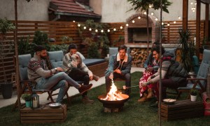 People in outdoor patio with fire pit