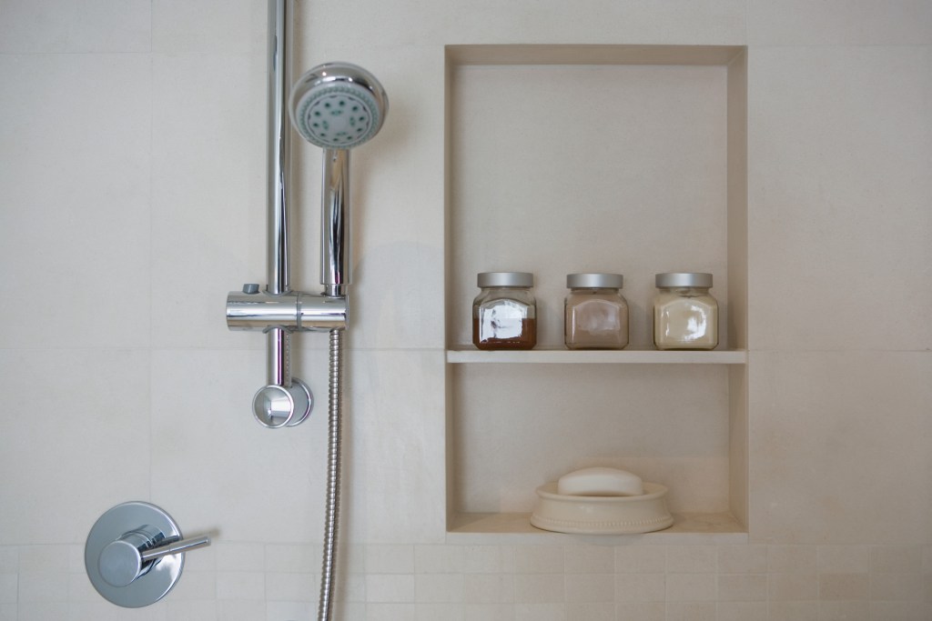 shower head next to shower niche