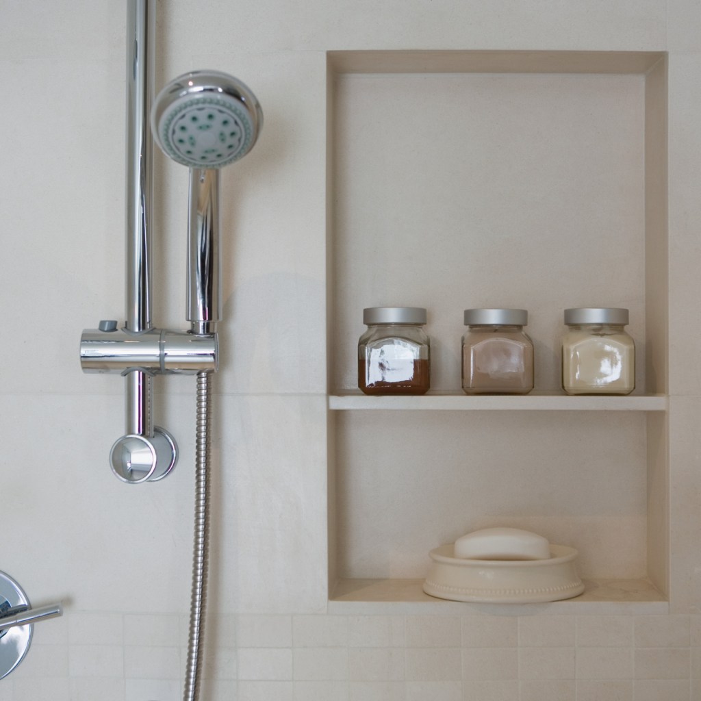 Shower head next to shower niche