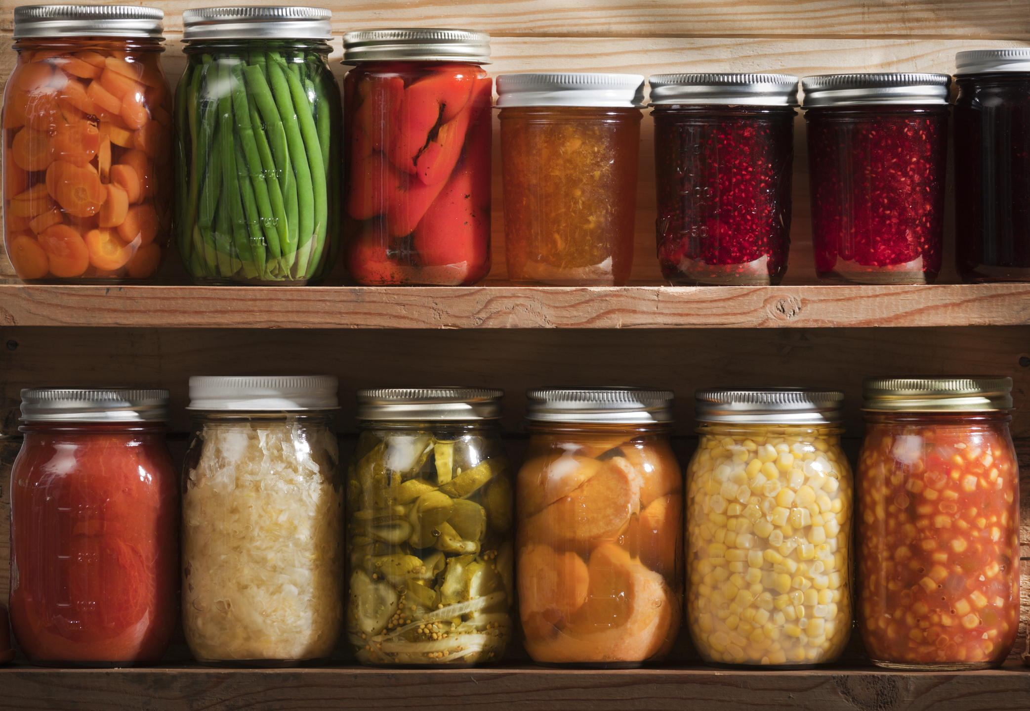 Home canning, preserving, pickling food stored on wooden storage shelves