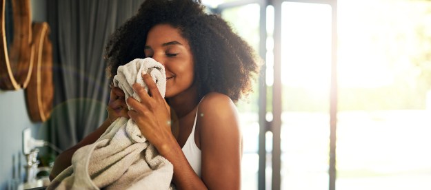 woman smelling towel