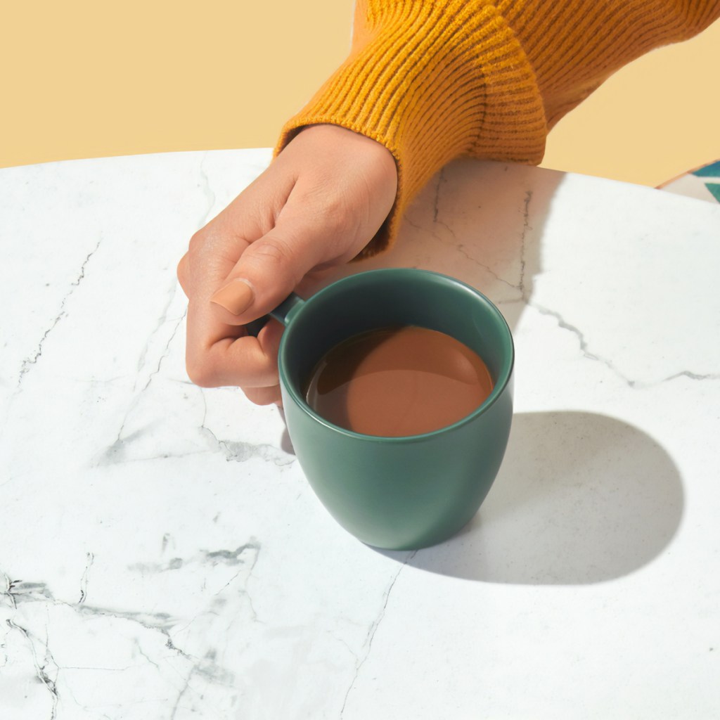 woman drinking coffee at table