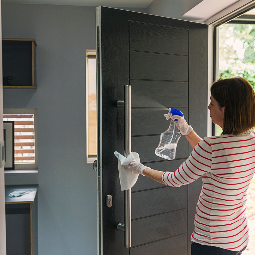 disinfecting and cleaning front door handle