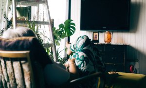 woman watching mounted tv