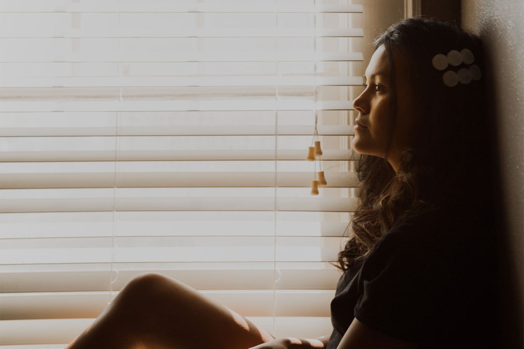 Woman with Venetian blinds