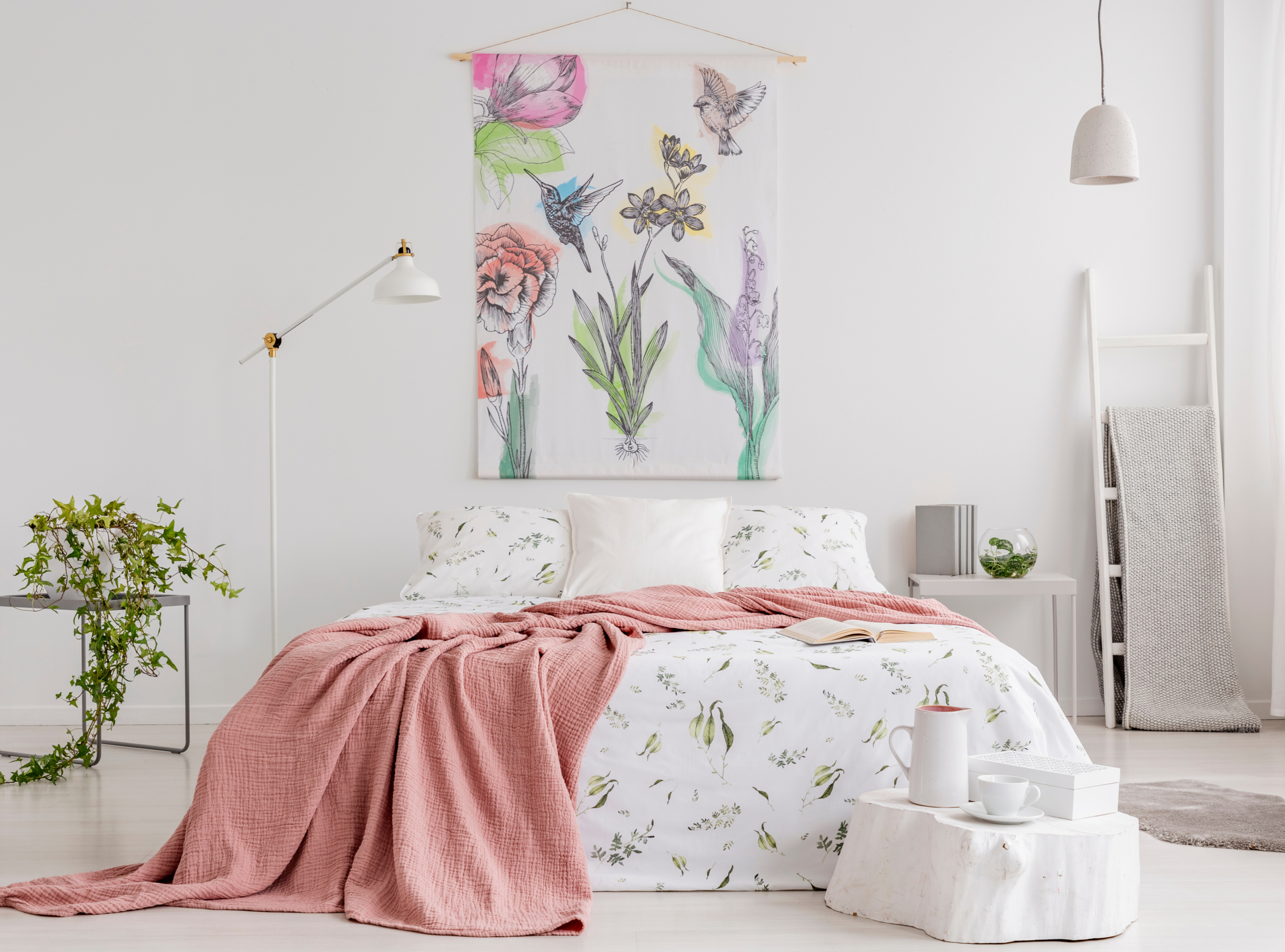 Simple flower tapestry hung above bed