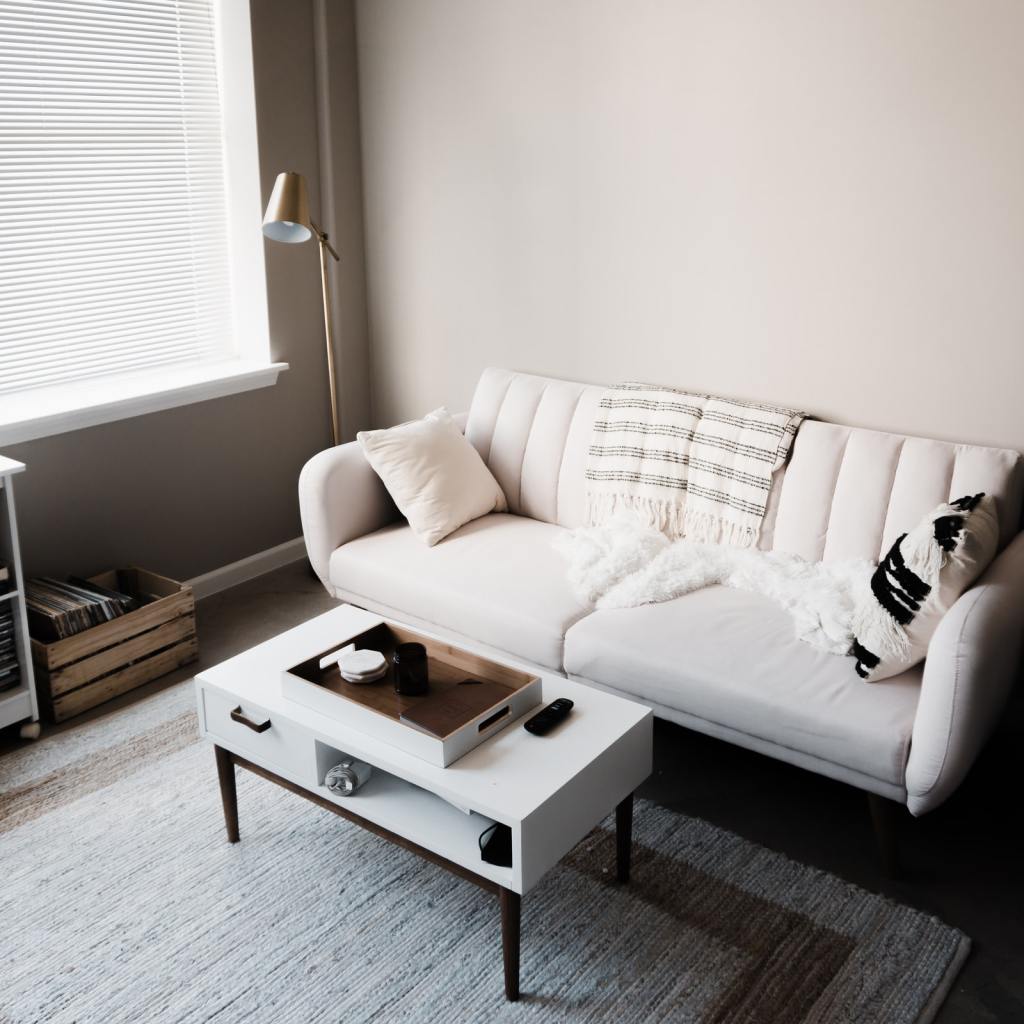 Neat living room with rug, coffee table, and small record player