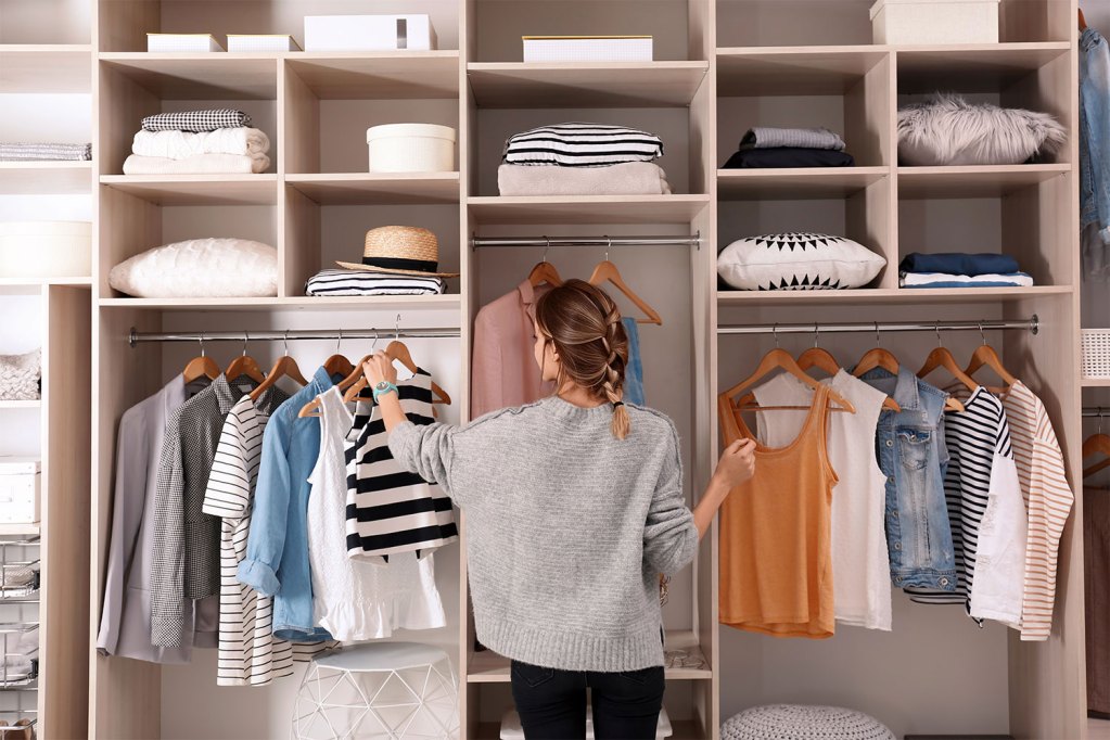Woman organizing her clothes closet