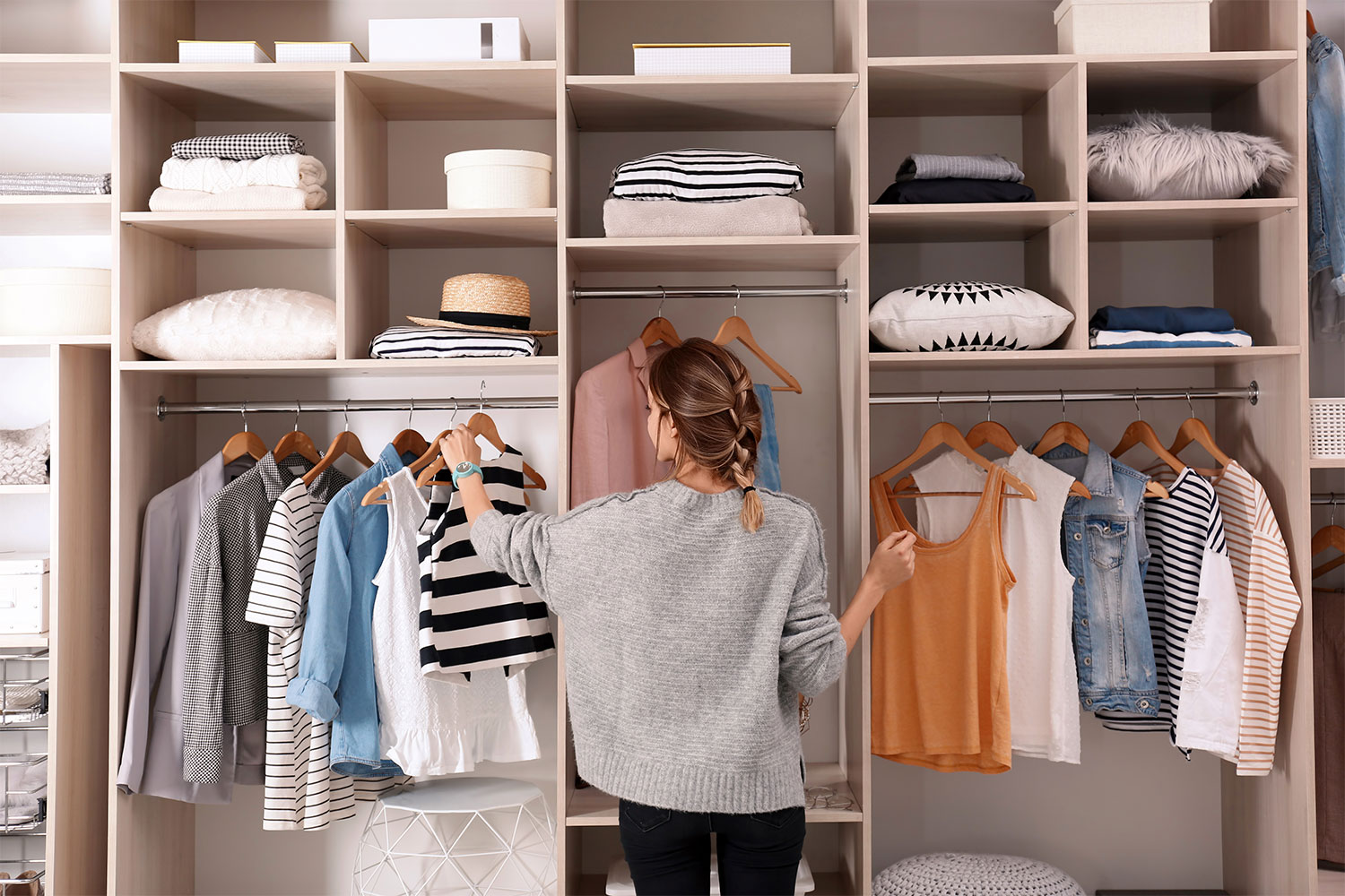 Woman organizing her clothes closet