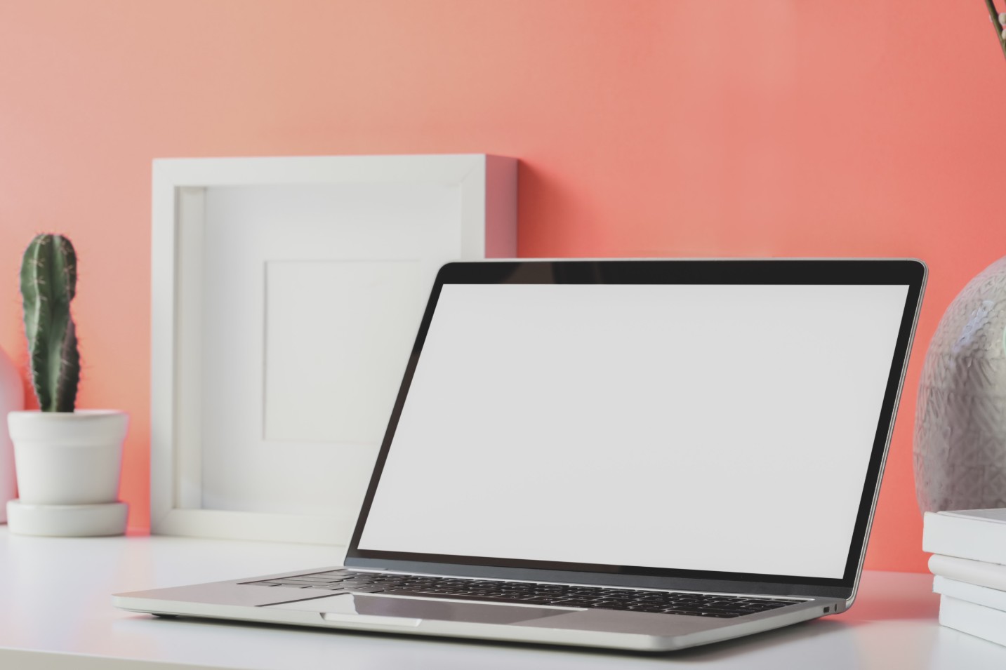 Laptop on desk with orange wall