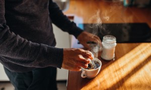 man preparing cup of coffee
