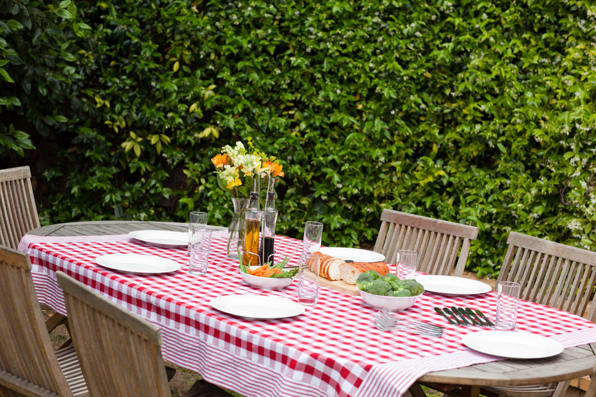 Wooden table with tablecloth on patio