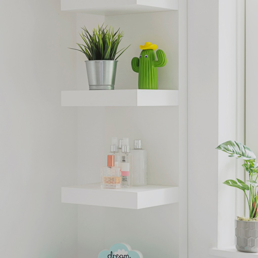 White floating shelves with plants on them