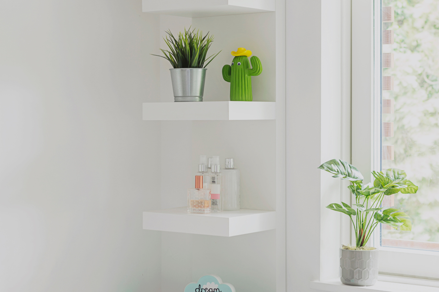 White floating shelves with plants on them