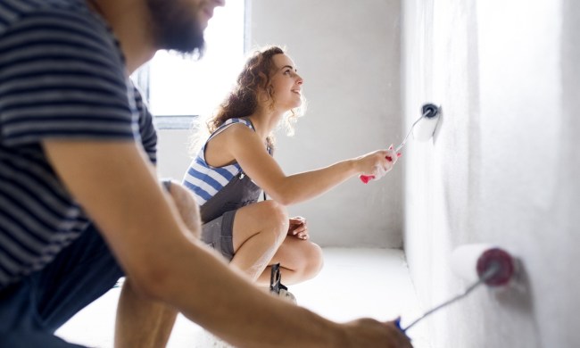Couple painting a wall