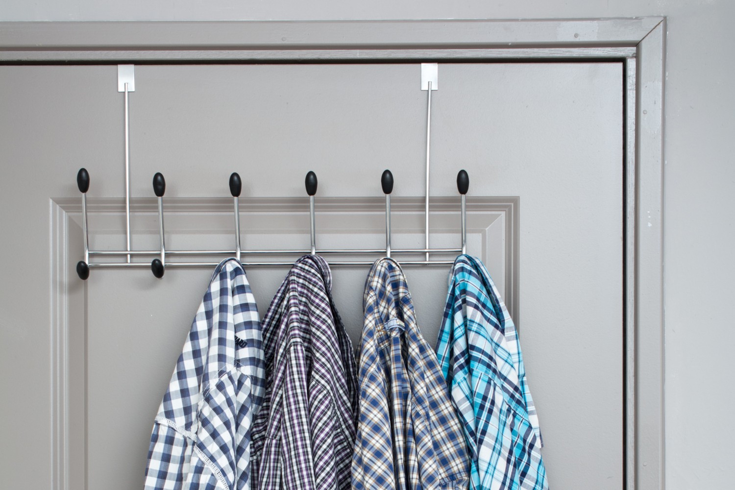 Shirts hanging hooks on the back of a door