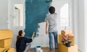 Wife and husband painting a wall