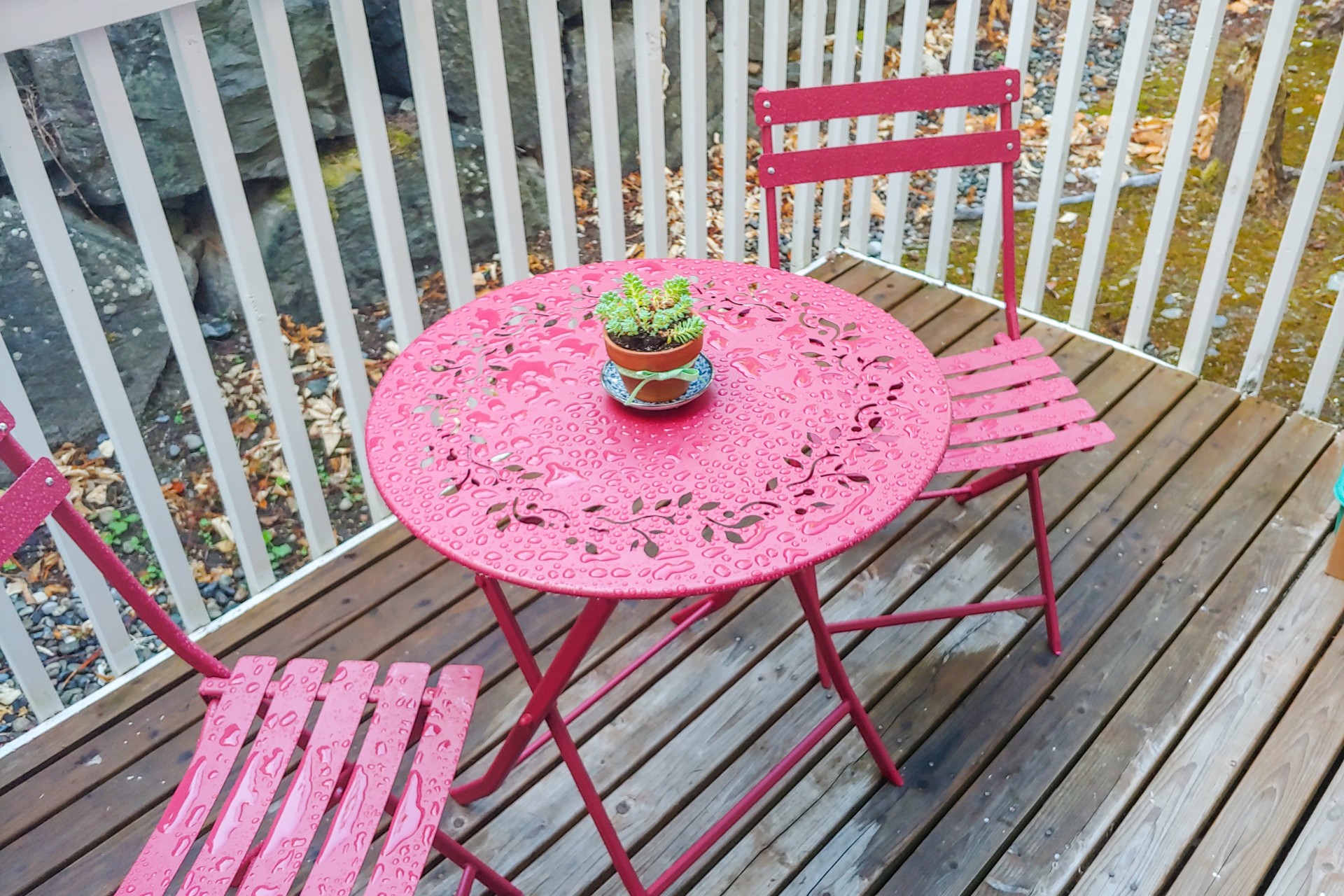 Two metal chairs with small metal table