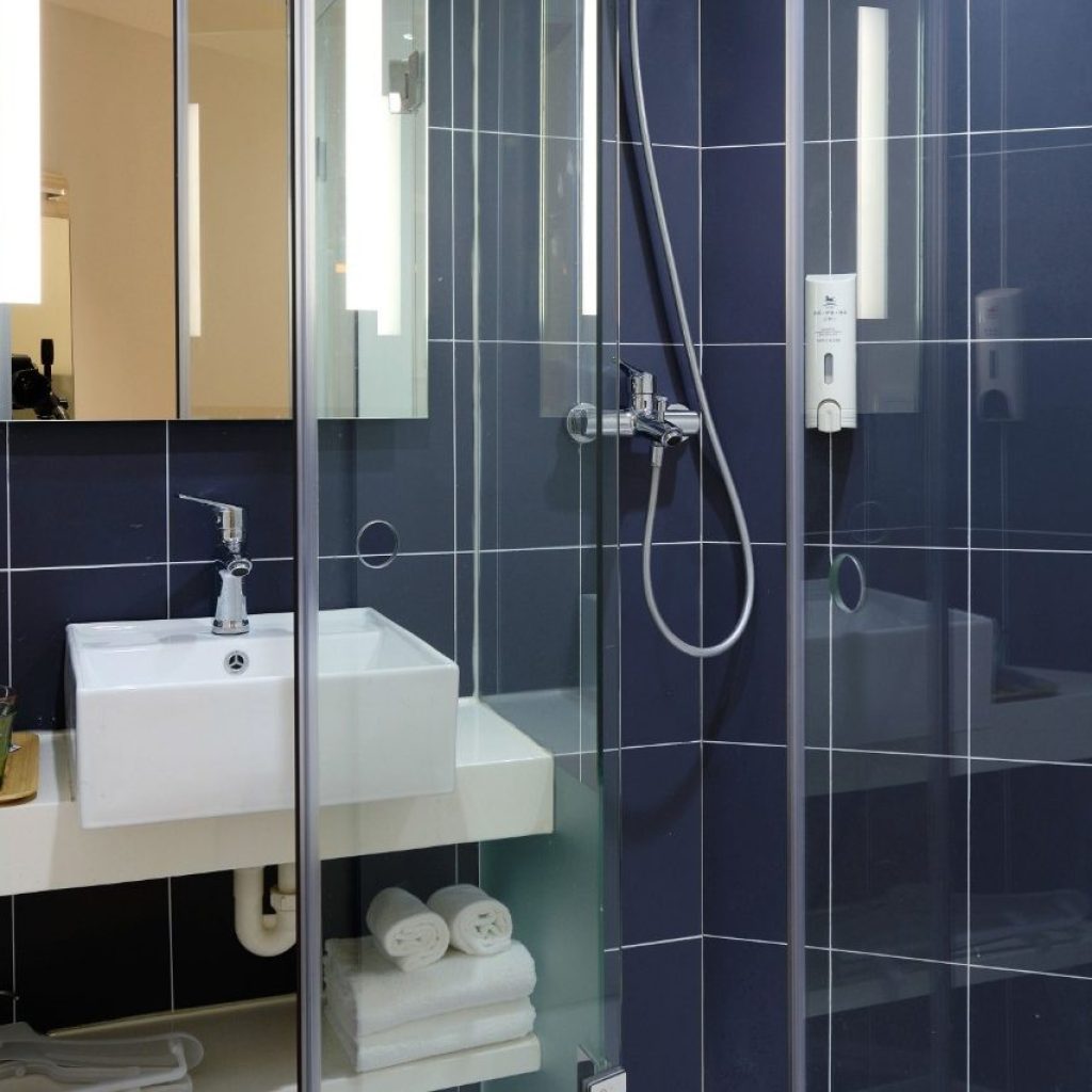 Bathroom shower with sink and shelves