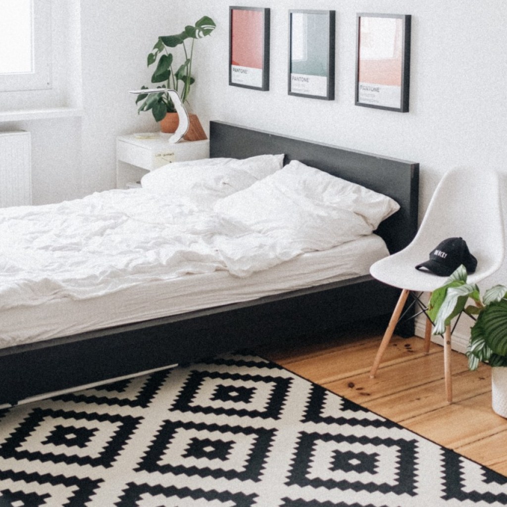 Bedroom with bed, carpet, and chair