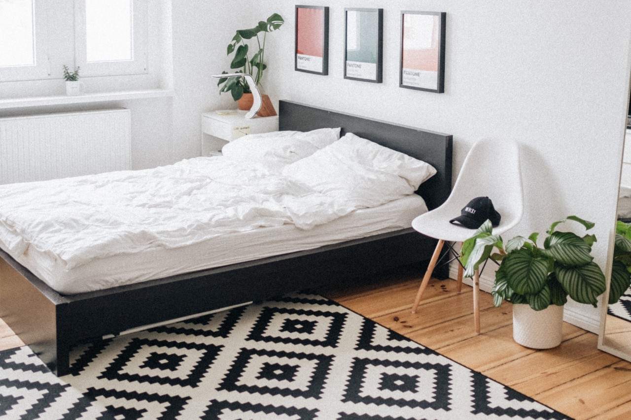 Bedroom with bed, carpet, and chair