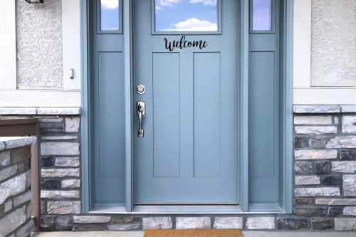 Blue door with "Welcome" sign