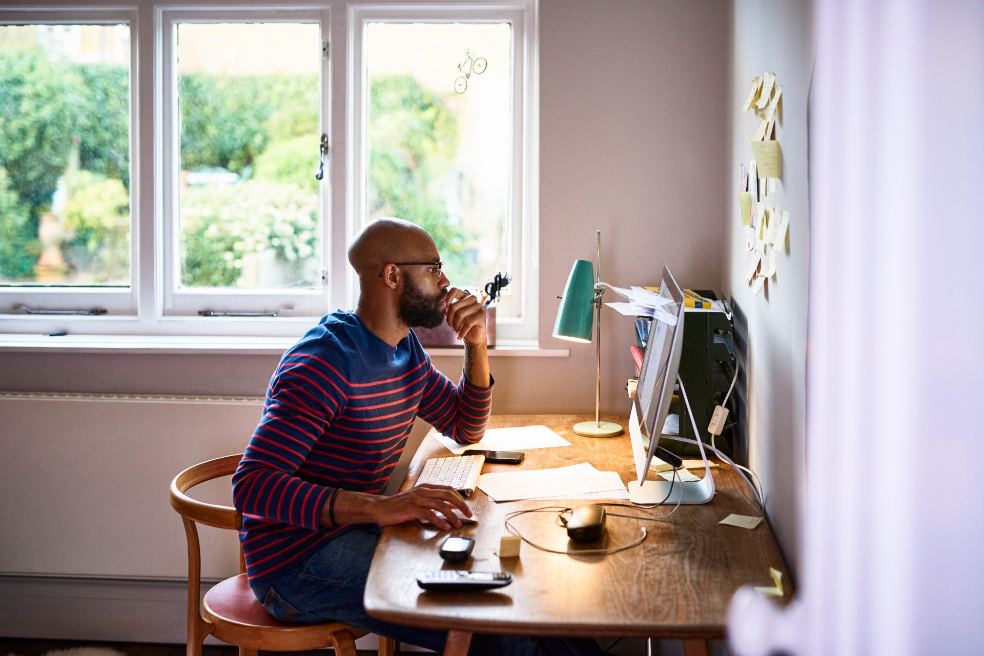 Man working at home with wooden desk