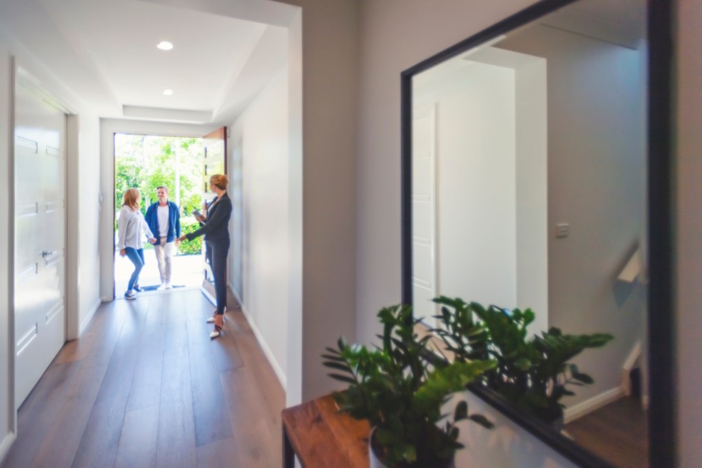 Woman welcoming friends at the front door