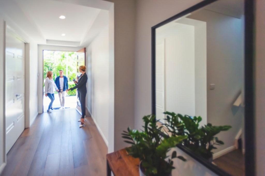 Woman welcoming friends at the front door
