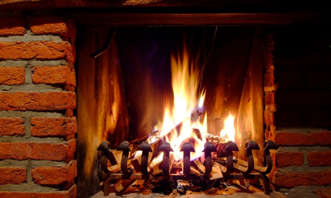 brick fireplace with fire burning