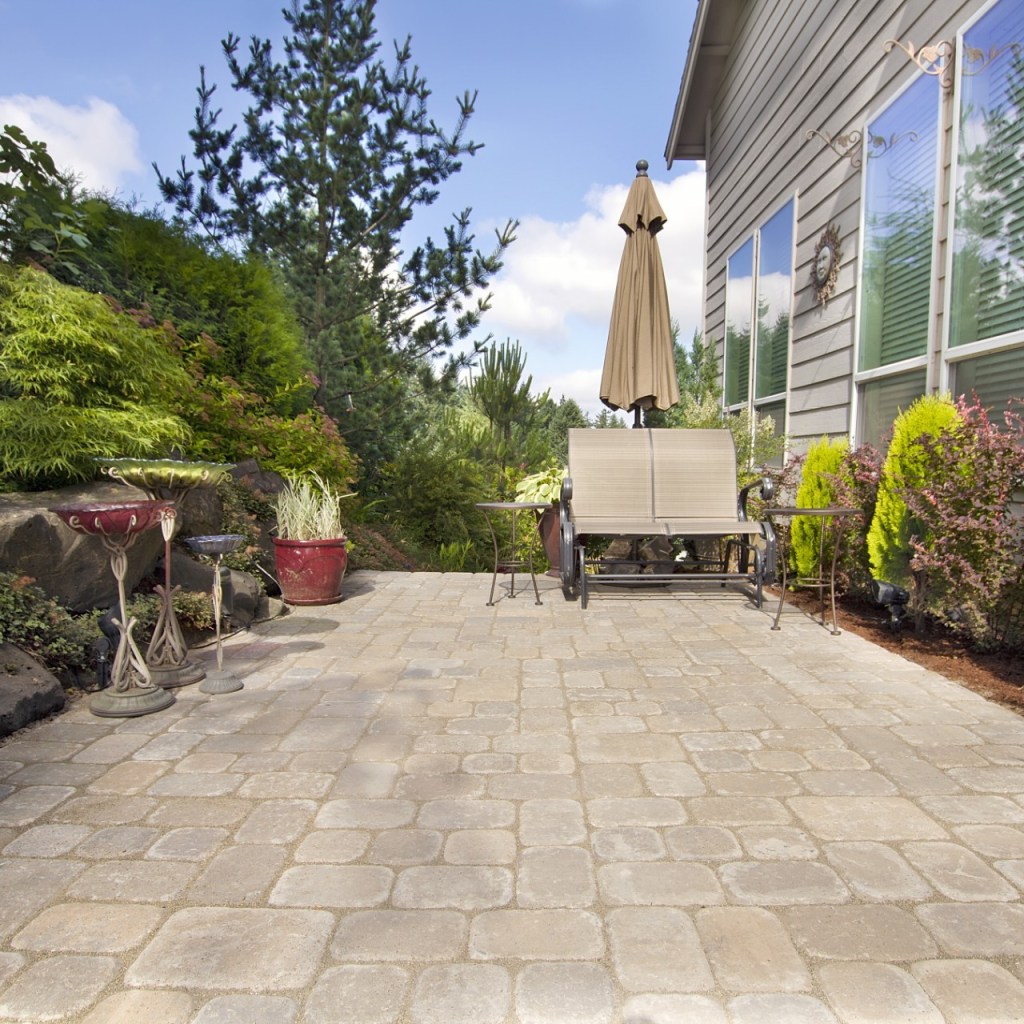 Backyard cement paver patio with bench
