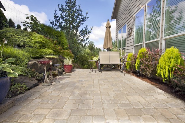 Backyard cement paver patio with bench