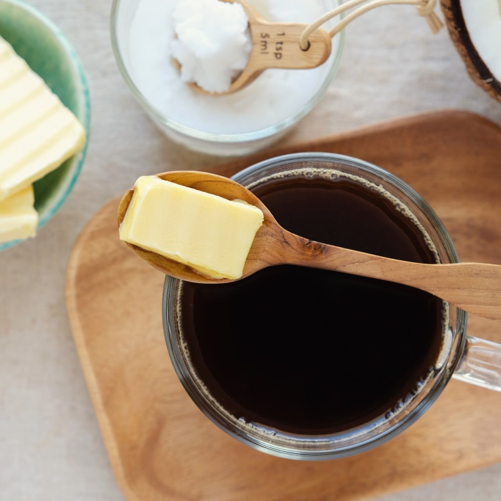 Coffee cup with butter on a spoon