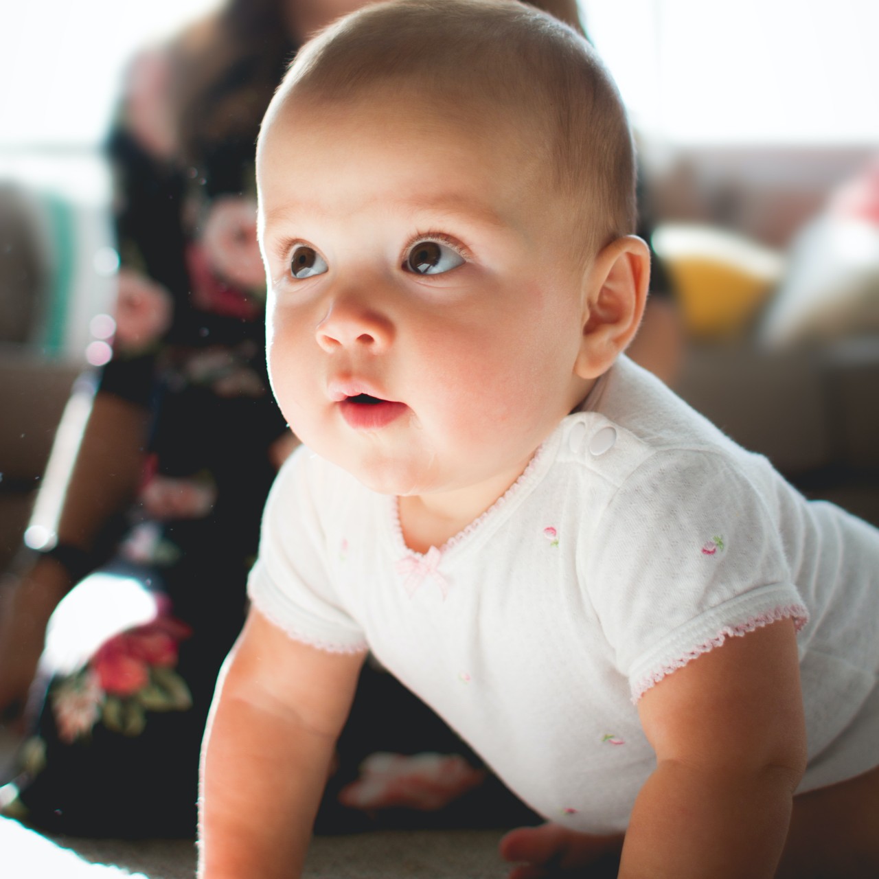 Toddler in T-shirt on floor