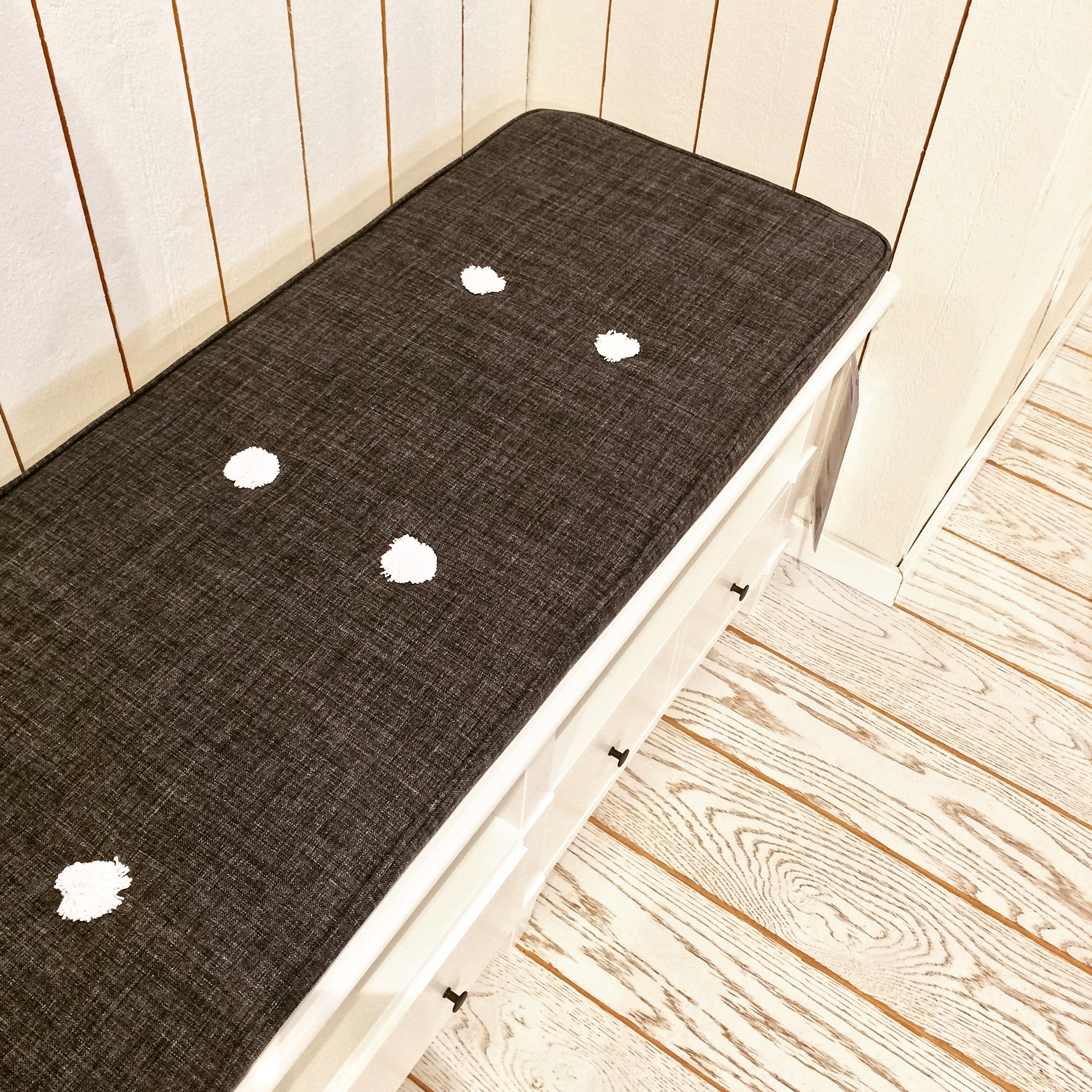 Bench with padded top on wooden deck