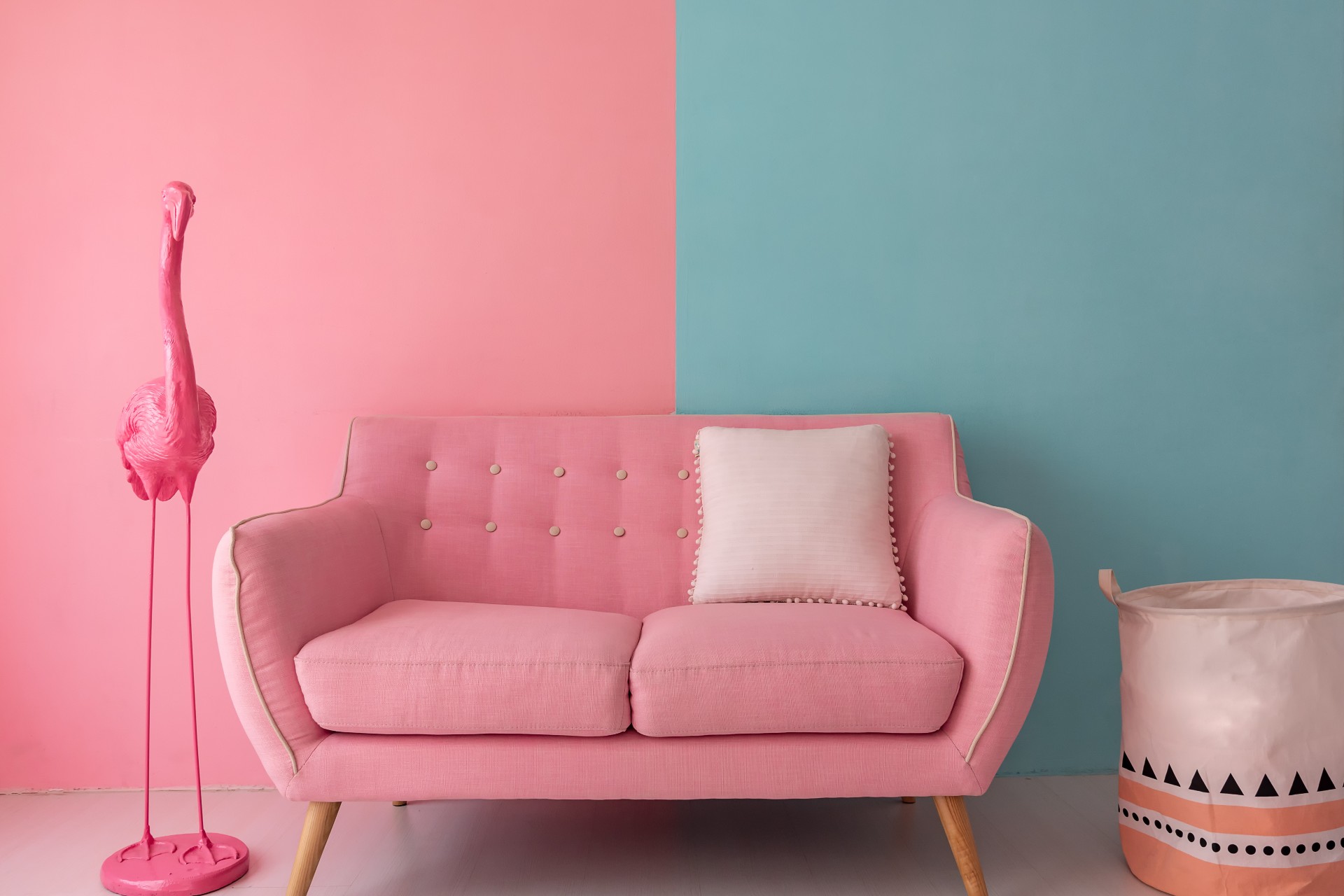 Pink couch against a pink and green wall