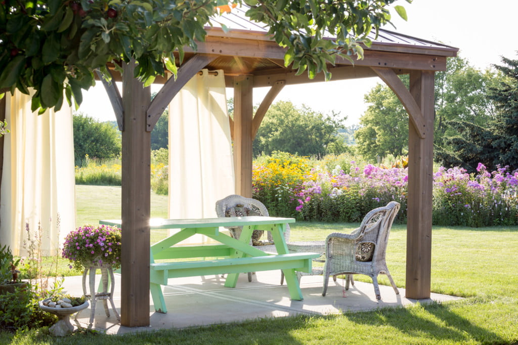 Pergola with picnic area and sheer white curtains
