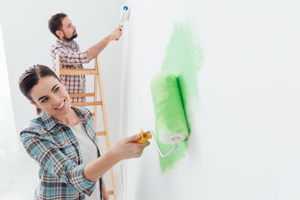 Couple painting white walls