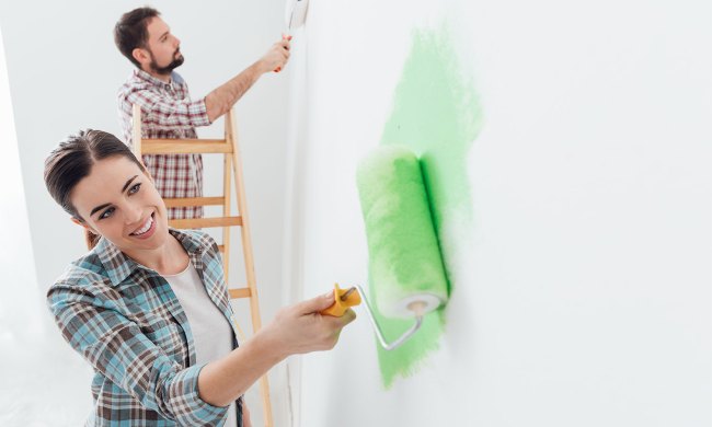 Couple painting white walls