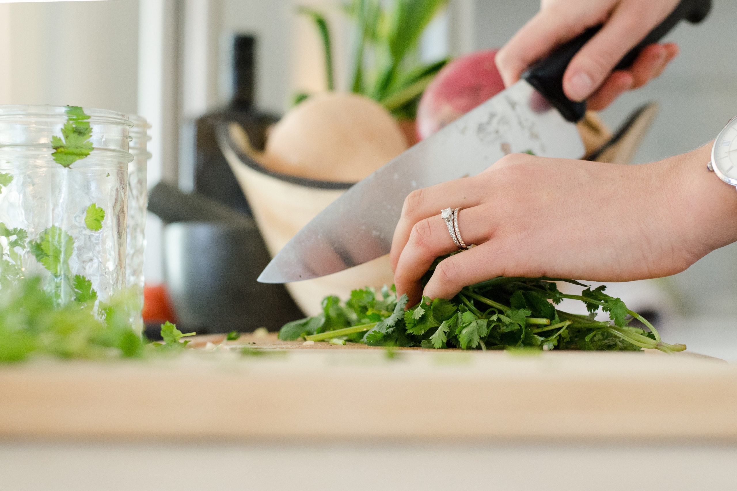 Close-up of a hand chopping vegatables