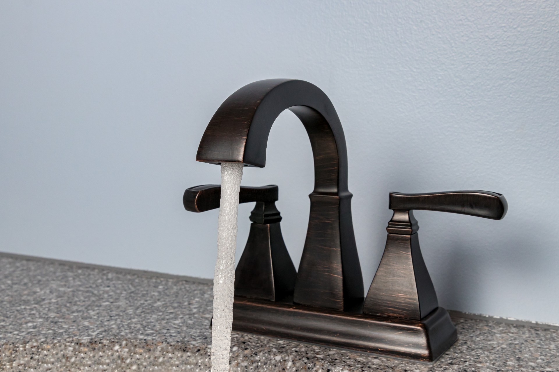 Black bathroom faucet with water running