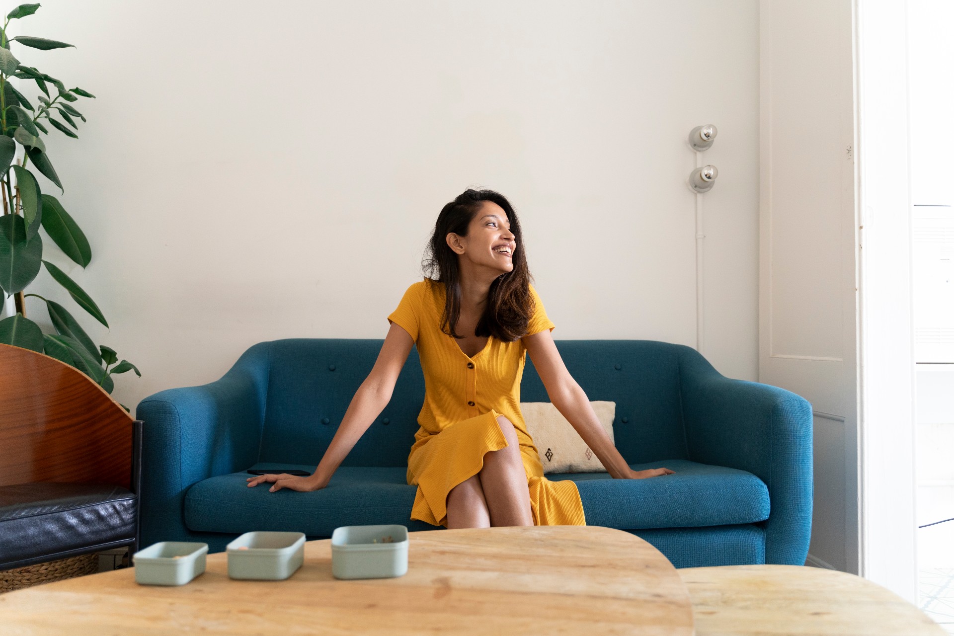 Woman sitting on a sofa near a coffee table